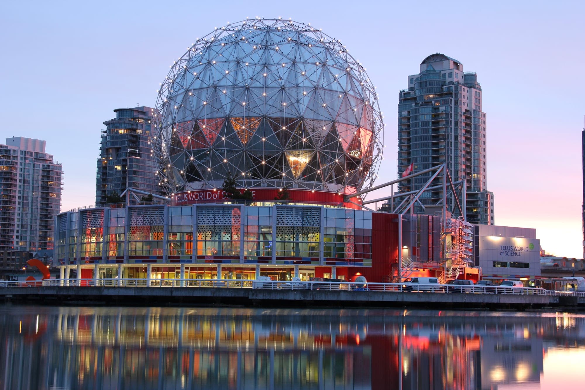 Science World geodesic dome on False Creek in Vancouver at night.