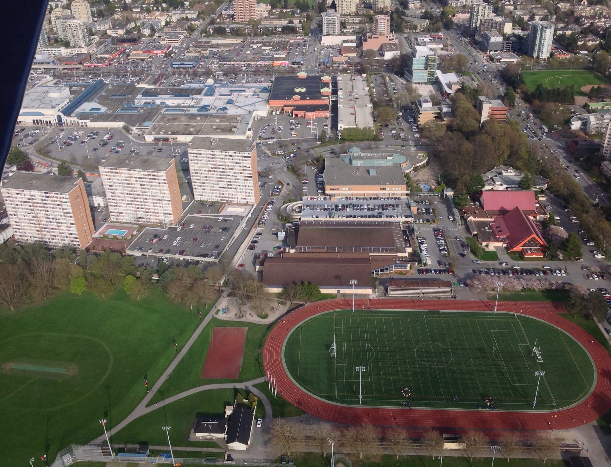 Aerial view of Minoru Park in central Richmond, showing the lake, sports fields, and surrounding residential neighbourhoods.