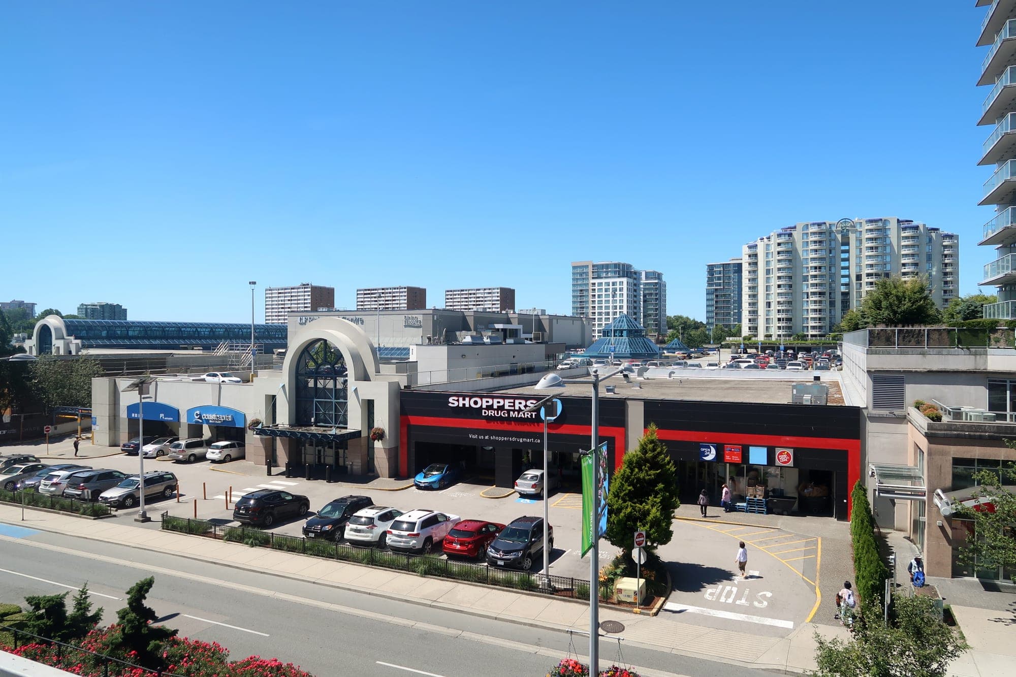 Exterior of CF Richmond Centre shopping mall in downtown Richmond City Centre, with the Canada Line SkyTrain running overhead.