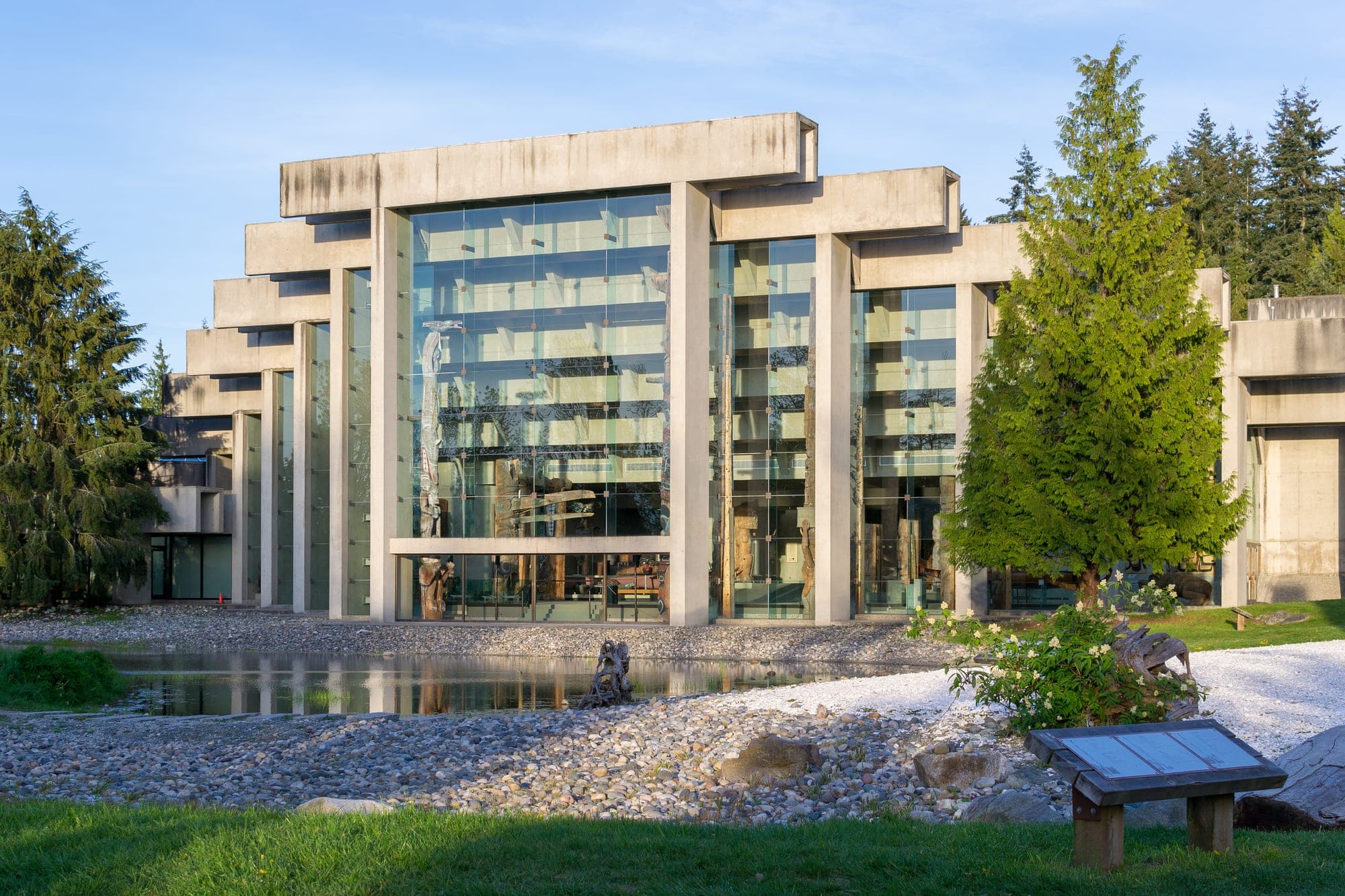 The Great Hall of the Museum of Anthropology at UBC in Vancouver, with tall glass walls framing Northwest Coast totem poles.