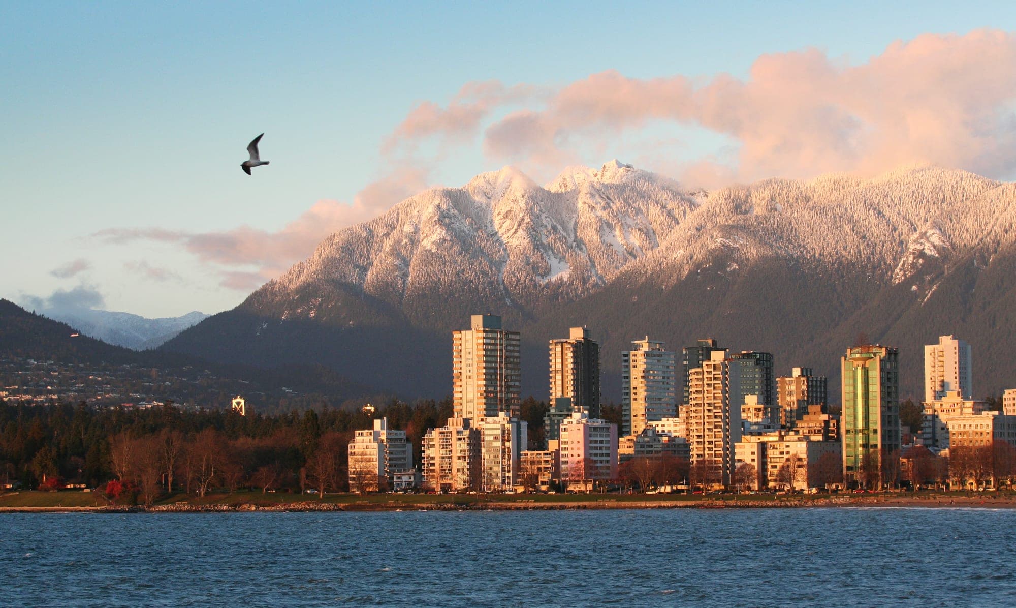 View of Vancouver's West End neighbourhood with dense residential high-rises set against the North Shore mountains.